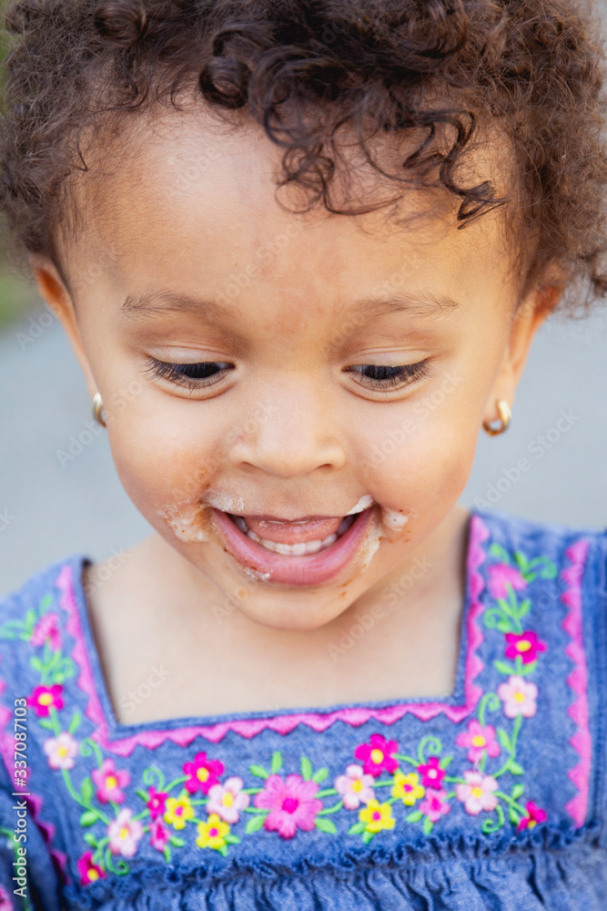 Closeup portrait of a smiling laughing happy child with messy icecream around her mouth. Closeup portrait of a smiling laughing happy child with messy icecream around her mouth.