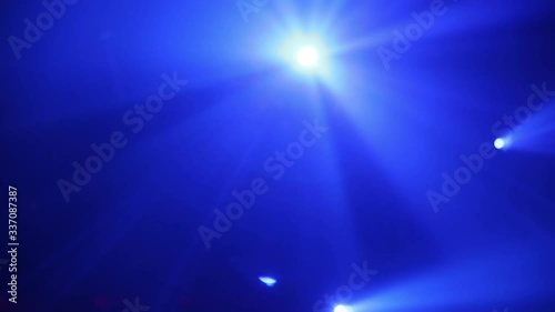 Blue Stage Ray Of Light In Concert Hall. Lighting lamp rays shiny dynamic effect. Laser lights on the stage.  Professional lighting and show effects.Professional lighting and show effects. photo