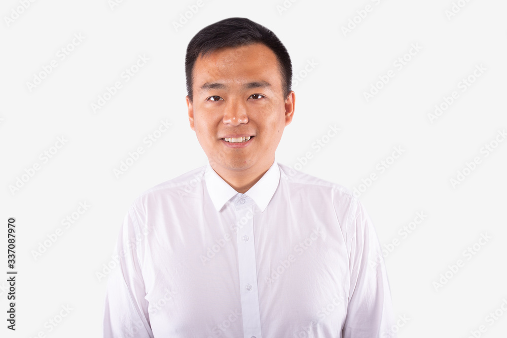 Young asian man in business shirt looks with smile. Isolated, white background Young asian man in business shirt looks with smile. Isolated, white background