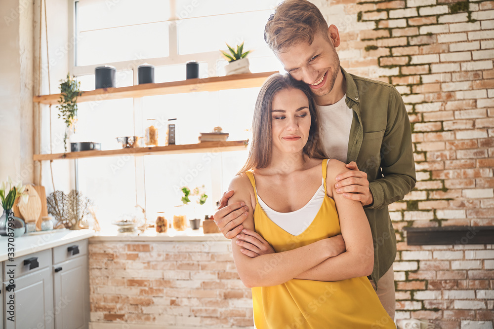 Positive delighted young couple being at home Positive delighted young couple being at home