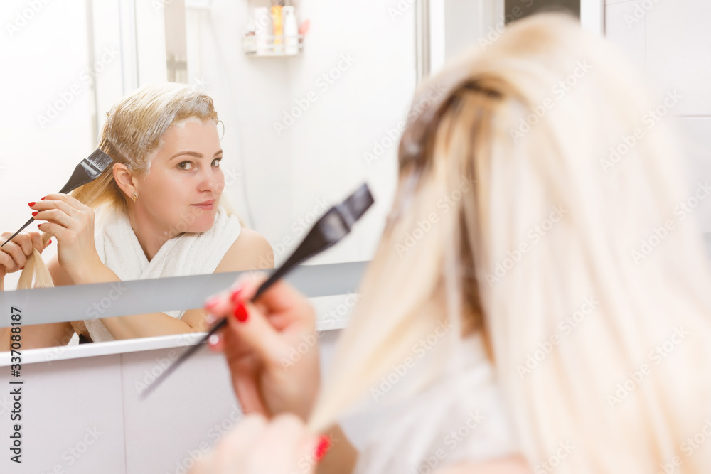 Hair dyeing in the domestic bathroom. One woman only Hair dyeing in the domestic bathroom. One woman only