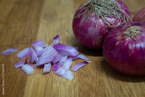 View of chopped red onions in a wooden board