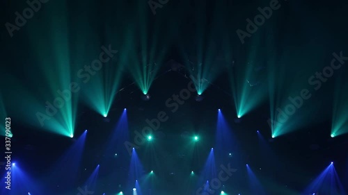 Stage Ray Of Light In Concert Hall. Lighting lamp rays shiny dynamic effect. Laser lights on the stage.  Professional lighting and show effects.Professional lighting and show effects. photo