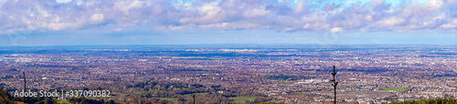 Stunning panoramic view of Dublin city and port from Ticknock, 3rock, Wicklow mountains. Gorse and forest plants in foreground during calm weather