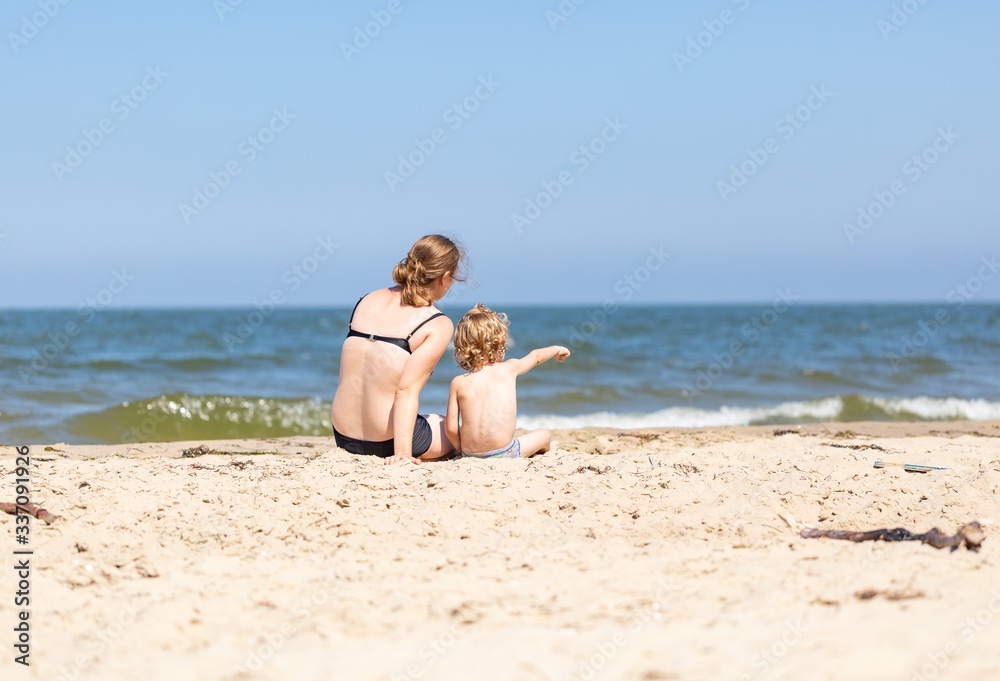 Mother and son spending time on sea shore Mother and son spending time on sea shore