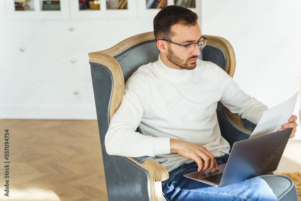 Man studying a document in his hand