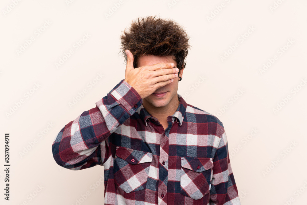 Young caucasian man covering eyes by hands. Do not want to see something Young caucasian man covering eyes by hands. Do not want to see something