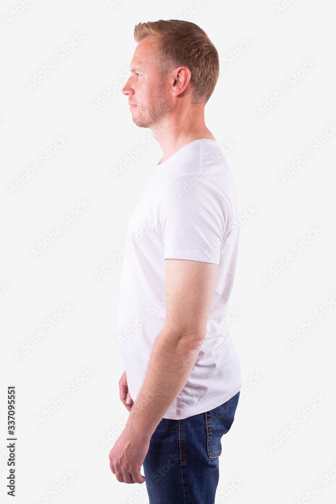 Caucasian man in casual wear stands sideways and looks ahead. White background Caucasian man in casual wear stands sideways and looks ahead. White background