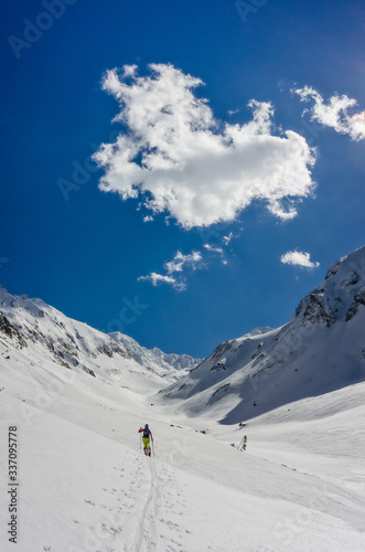 Girl ski touring on a bright sunny day © catgrig