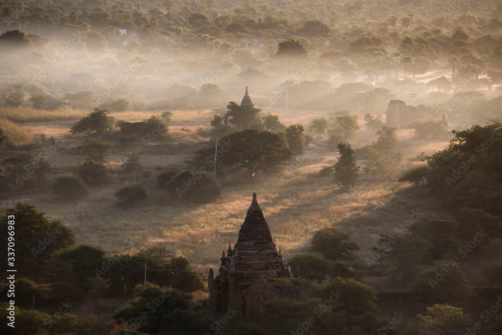 fog lifting above ancient temples of Bagan Myanmar at sunrise