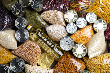 Donations food with canned food on the table background. Donate concept. Close up.