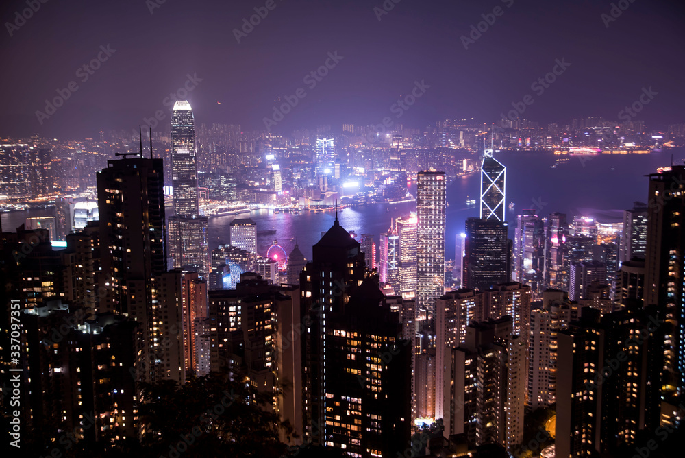 hong kong city skyline at night with glowing buildings