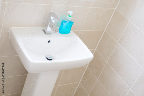 Anti-bacterial blue hand wash on hand basin to prevent coronavirus and other germs or virus 