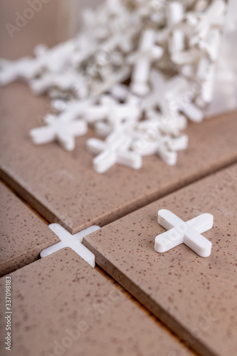 Industrial tiles and plastic crosses for tiling. Accessories for construction workers.