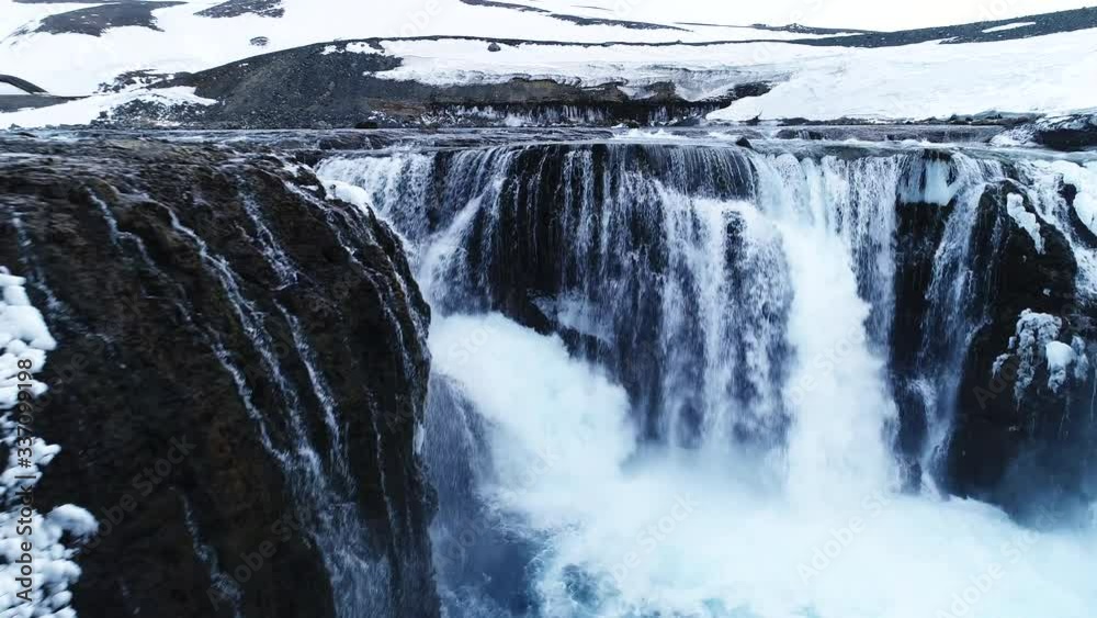 Aerial, snowy Iceland waterfall Aerial, snowy Iceland waterfall