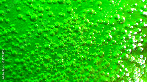 Floating Green Sparkling Liquid Soap Bubbles For a Halloween Chemical Lab Effect Textures and Background