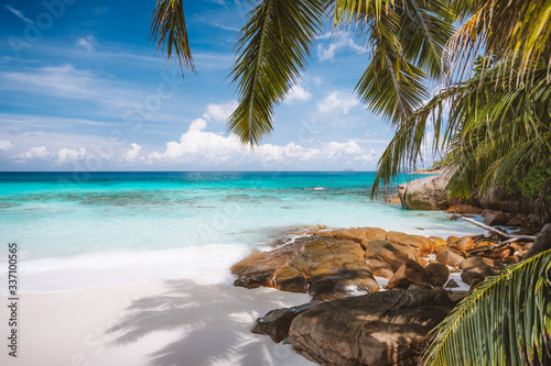 Fototapeta Naklejka Na Ścianę i Meble -  Vacation holiday landscape of prisine tropical paradise beach with crystal clear blue water, powdery white sand and impressive white clouds