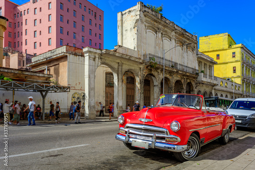 Havana Cuba Red vintage classic american car in a typical colorful street with sunny blue sky 