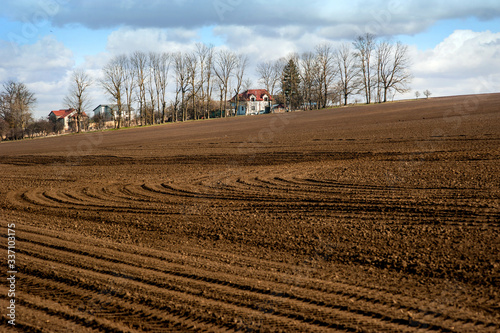 brown arable fields when preparing land for sowing in early spring
