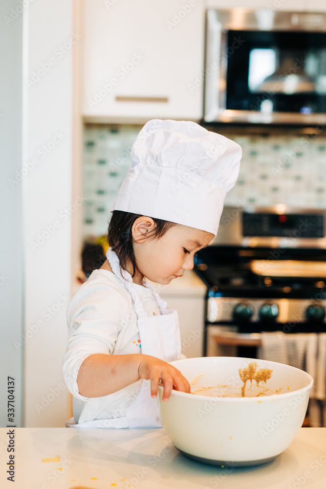 Toddler Girl Baking Cookies Wearing Toque Toddler Girl Baking Cookies Wearing Toque