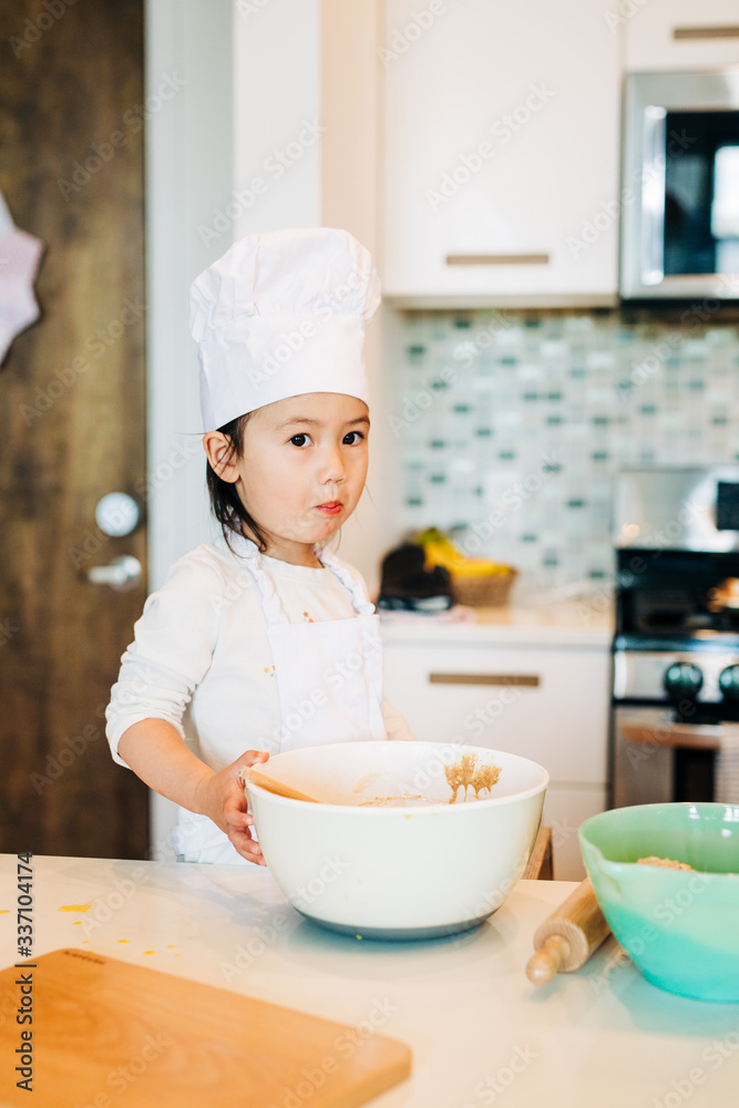 Toddler Girl Baking Cookies Wearing Toque Toddler Girl Baking Cookies Wearing Toque