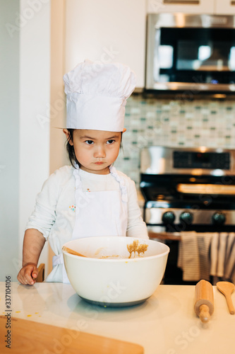 Toddler Girl Baking Cookies Wearing Toque