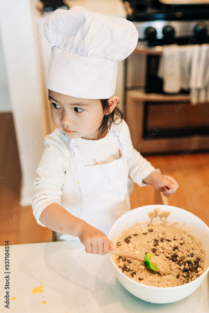 Toddler Girl Baking Cookies Wearing Toque Toddler Girl Baking Cookies Wearing Toque