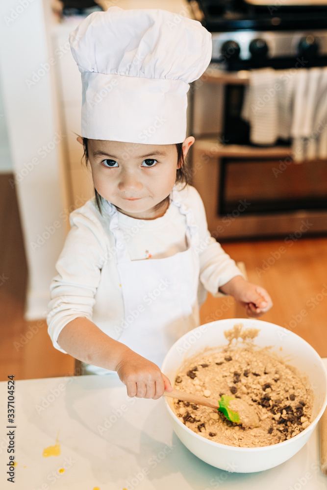 Toddler Girl Baking Cookies Wearing Toque Toddler Girl Baking Cookies Wearing Toque