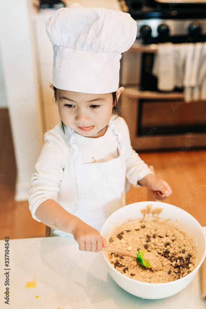 Toddler Girl Baking Cookies Wearing Toque Toddler Girl Baking Cookies Wearing Toque