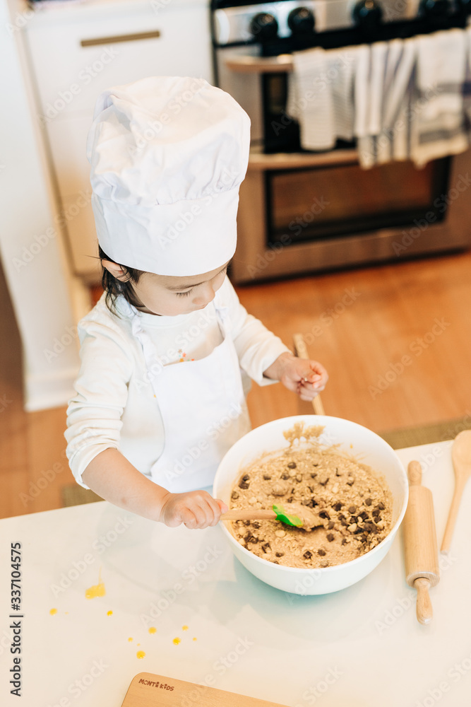 Toddler Girl Baking Cookies Wearing Toque Toddler Girl Baking Cookies Wearing Toque