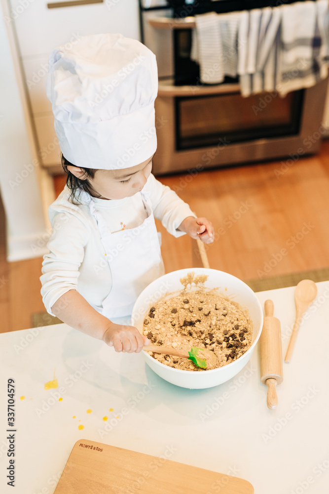 Toddler Girl Baking Cookies Wearing Toque Toddler Girl Baking Cookies Wearing Toque