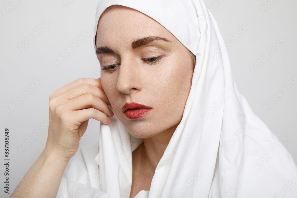 Side portrait of a beautiful young Muslim woman wearing a hijab on her head. Side portrait of a beautiful young Muslim woman wearing a hijab on her head.