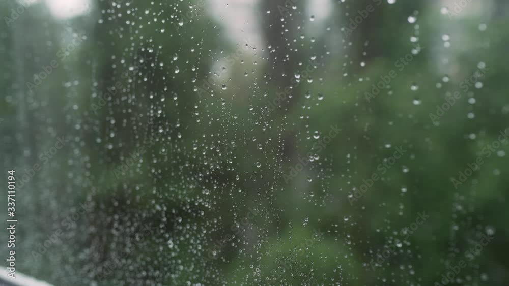 Raindrops on the window close-up, it is raining outside the window Raindrops on the window close-up, it is raining outside the window