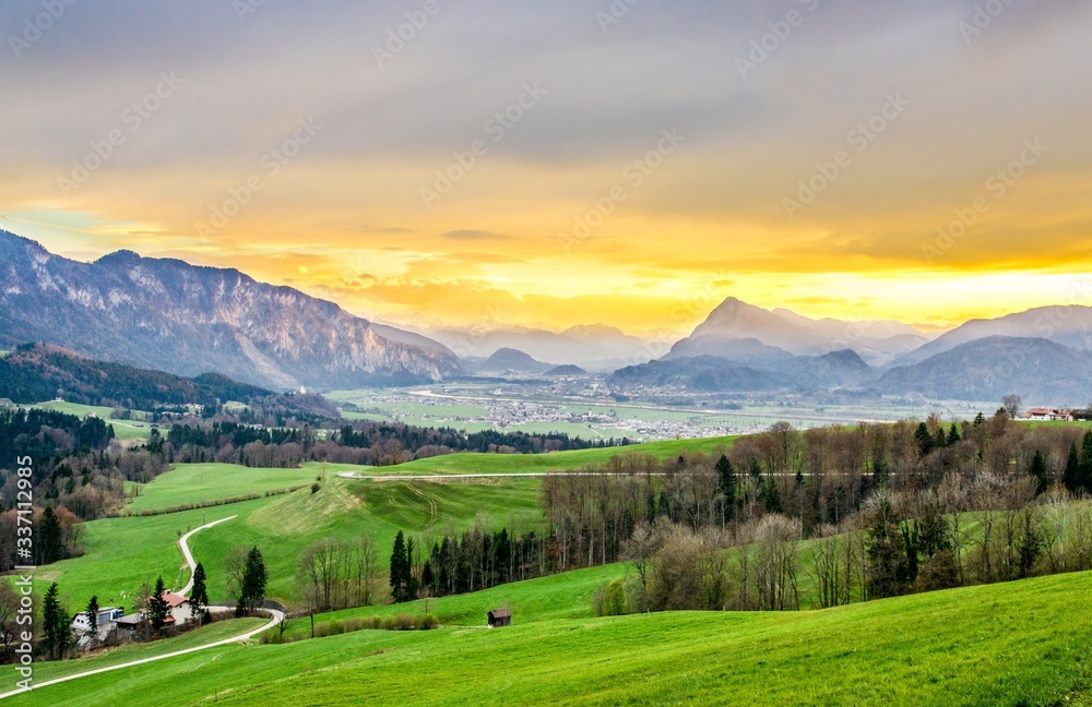 Beautiful sunset panorama view in Inntal on alps in Tirol, Austria. With green fields near Kufstein, Kaiser, Kaisergebirge, border with Bavaria (Bayern) Germany