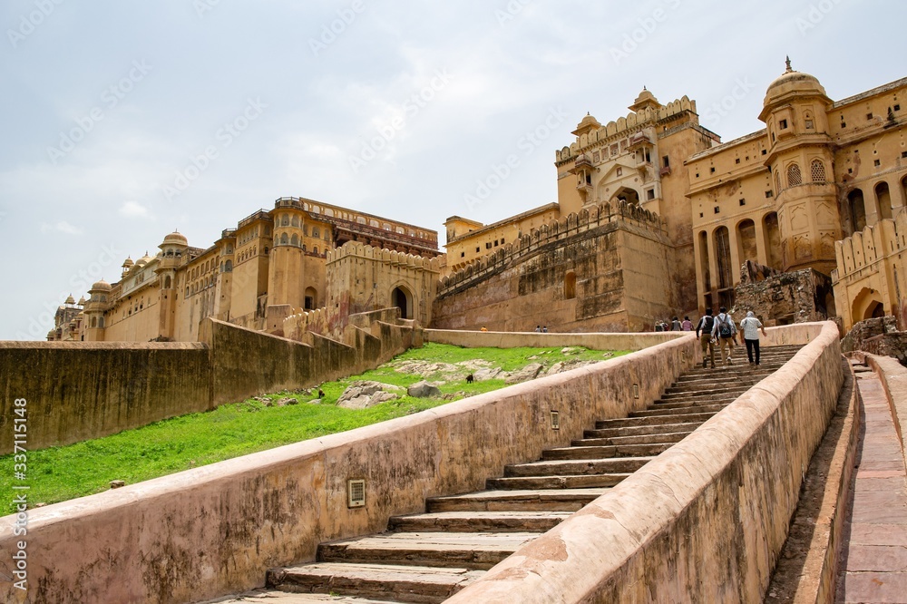 A staircase to Amber Fort in Jaipur, India with tourists going upstairs