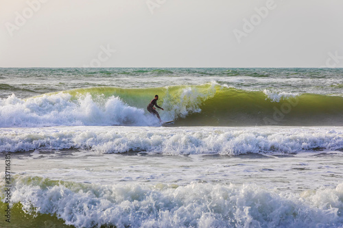 Surfers ride the waves on t...