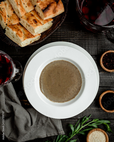 a bowl of mushroom soup served with tandoor bread