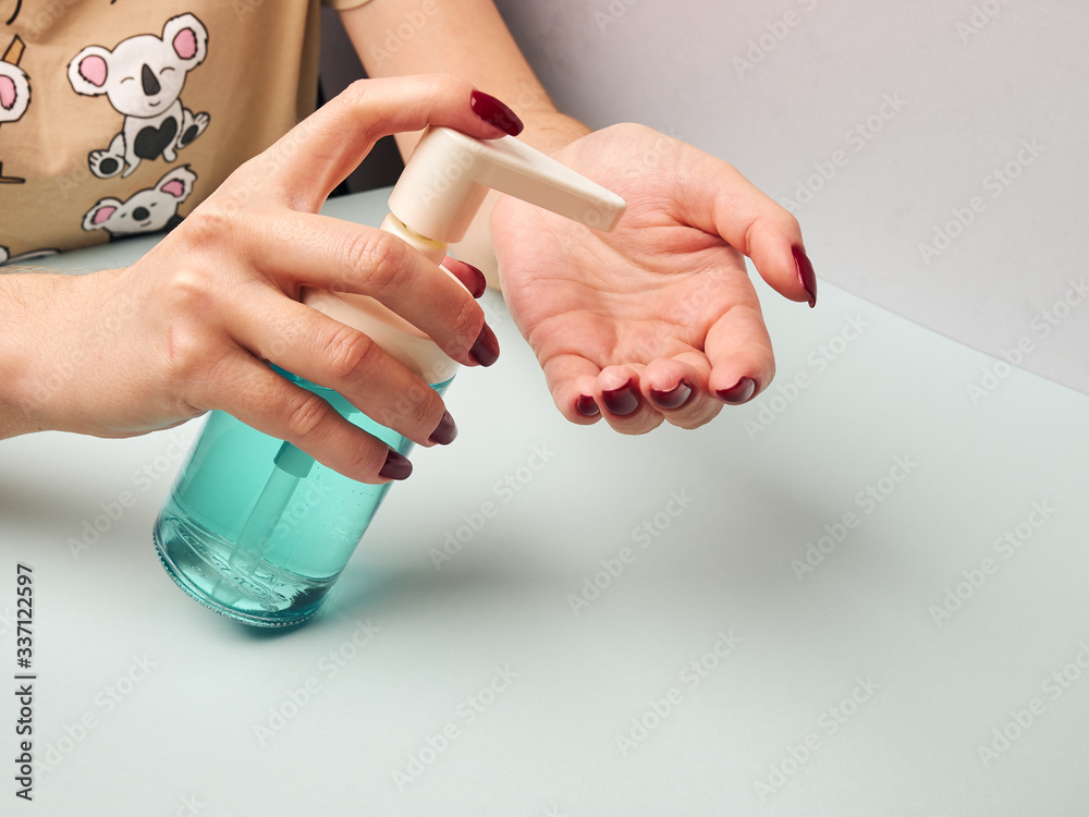 Woman disinfects her hands with an antiseptic spray can. Prevention in the fight against coronavirus. Selected Focus. Woman disinfects her hands with an antiseptic spray can. Prevention in the fight against coronavirus. Selected Focus.