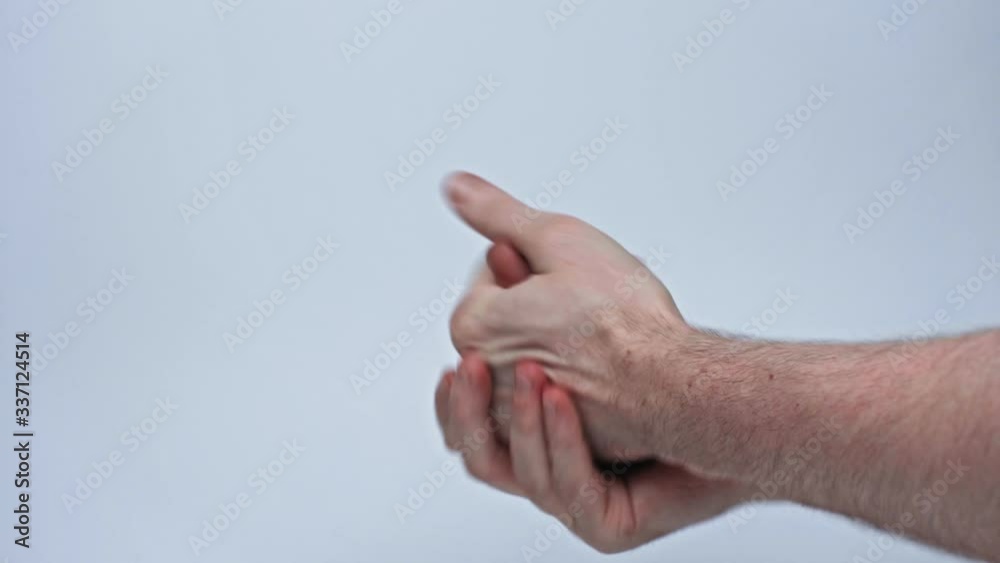 A man washes his hands with a disinfectant against infection with coronavirus during quarantine. Isolated on a gray background in the studio. Coronavirus concept A man washes his hands with a disinfectant against infection with coronavirus during quarantine. Isolated on a gray background in the studio. Coronavirus concept