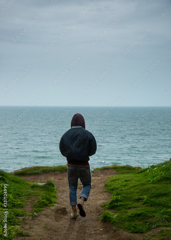 Man walking near ocean