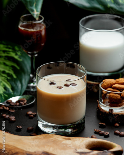 a glass of coffee cocktail garnished with coffee beans
