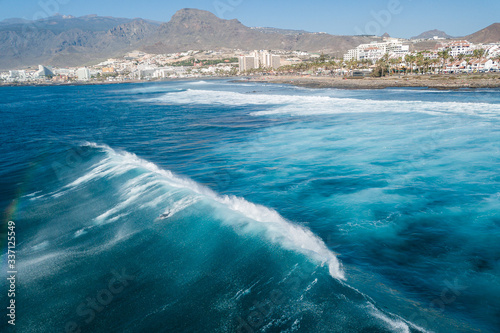 Photography Tenerife surfers on the beach of Las Americas ride the waves