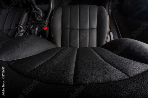 the interior of the car is covered with handmade genuine leather. front car seat. wide top view from the headrest to the seat. © Sasha