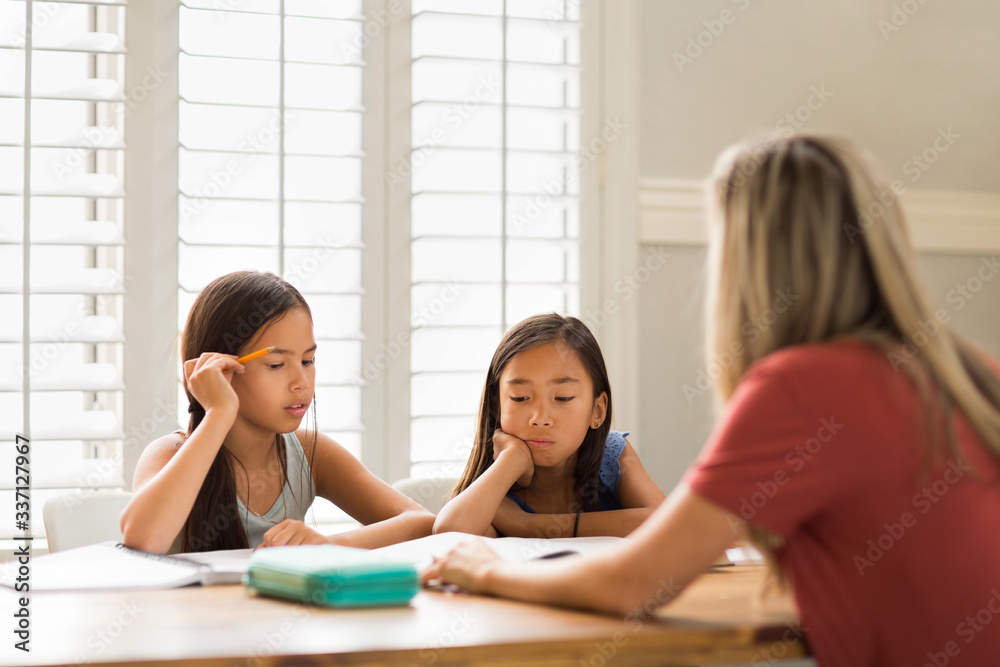 Mother Helping Her Daughters With Their Homework