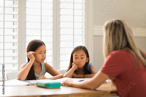 Mother Helping Her Daughters With Their Homework
