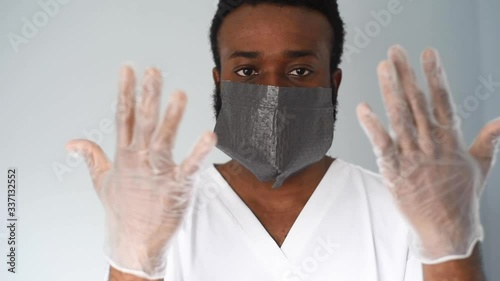 Doctor in mask. Black man african american doctor portrait wearing safety mask at work. Medical staff. Coronavirus.