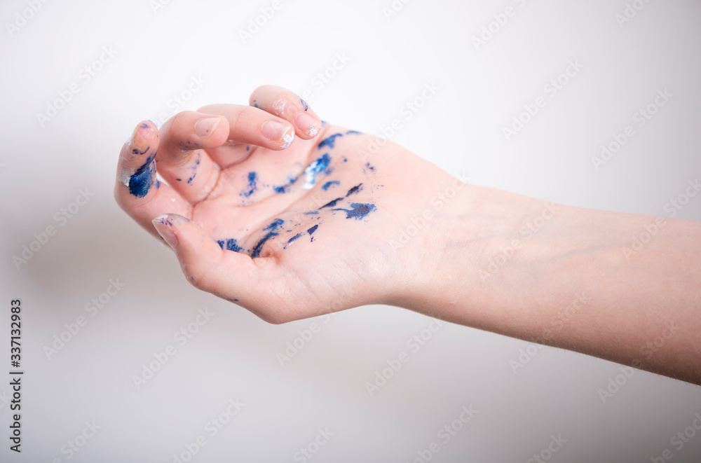 Artist hands covered in paint on light background Artist hands covered in paint on light background