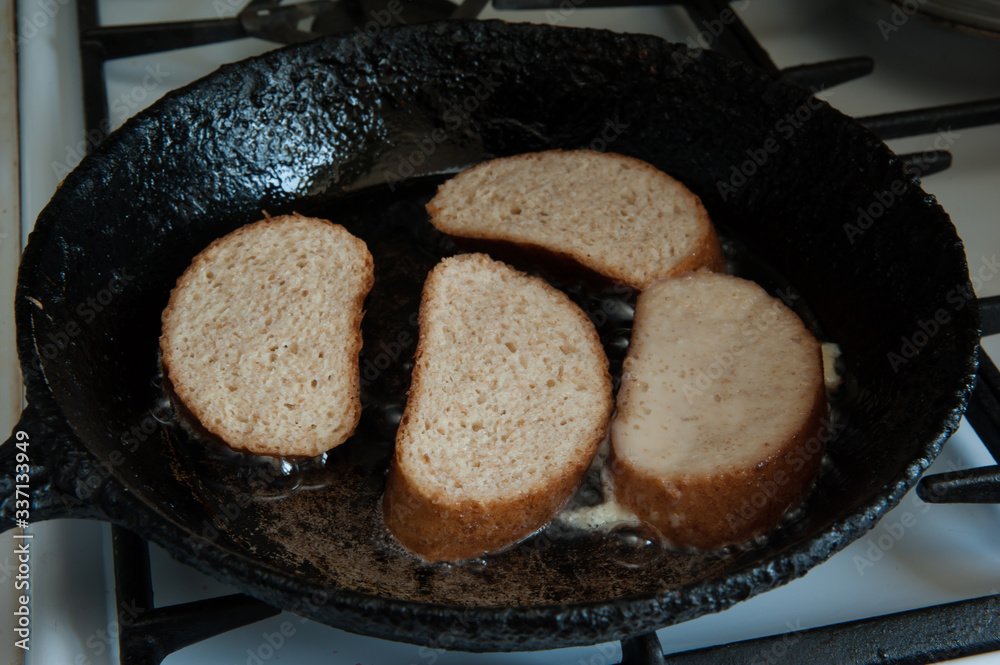 Home cooking. Frying pan with French toast close-up. Selective focus. Home cooking. Frying pan with French toast close-up. Selective focus.