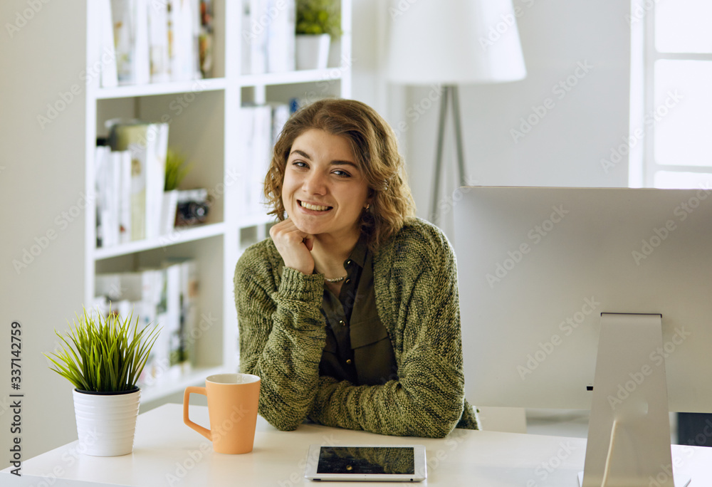 Young woman working with graphic tablet in office Young woman working with graphic tablet in office