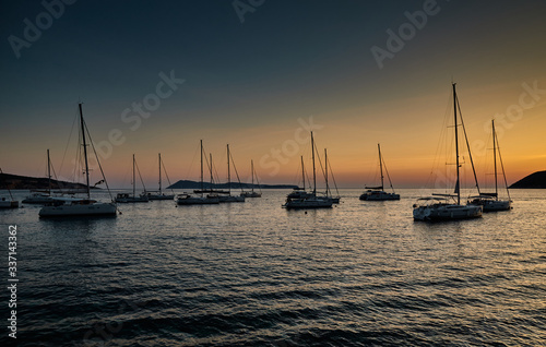 Parking of sailboats at marina in Croatia at sunset, The picturesque horizon, islands on a background, orange color